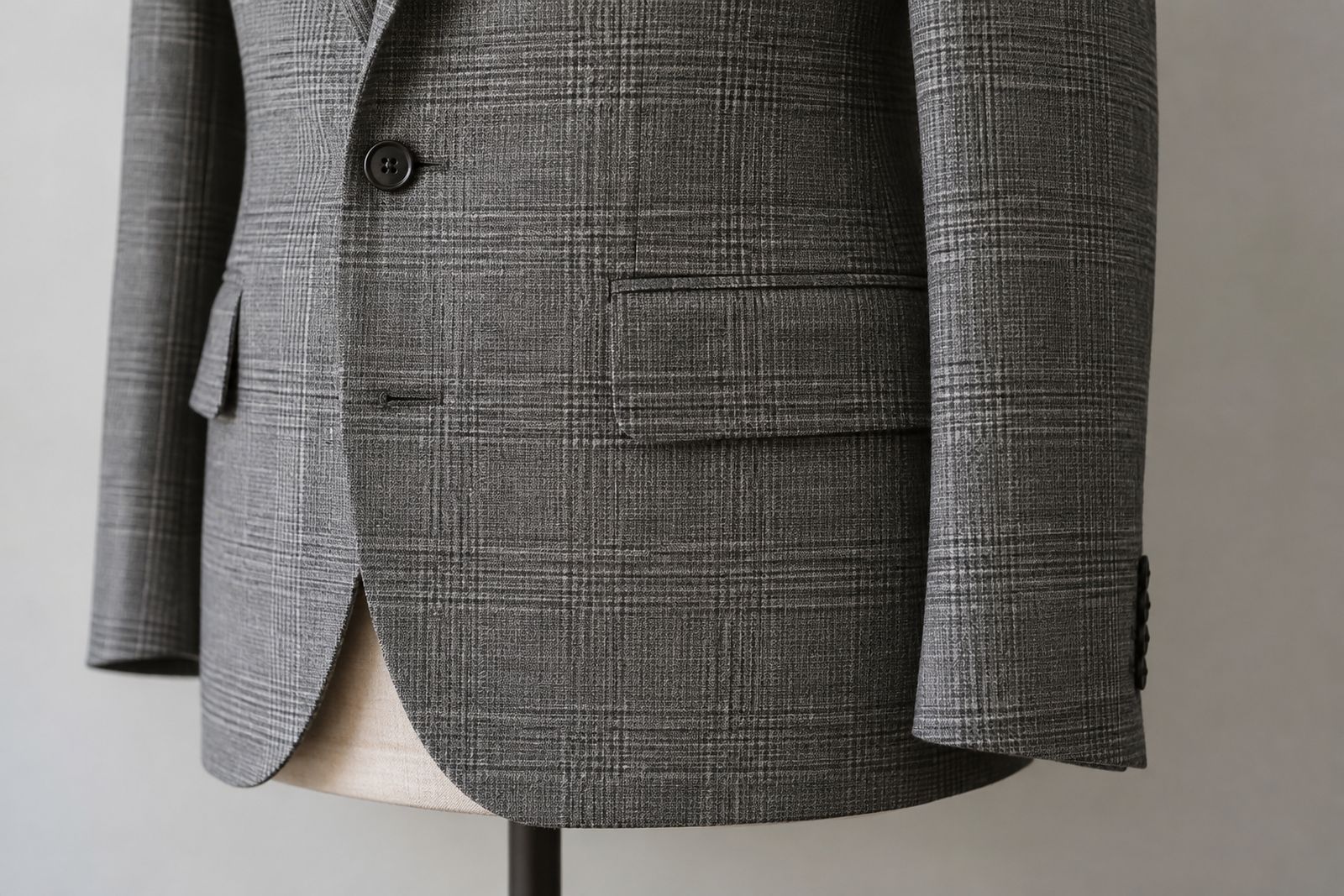 A gray check jacket where the check pattern on the pocket flap lines up with the body behind it.