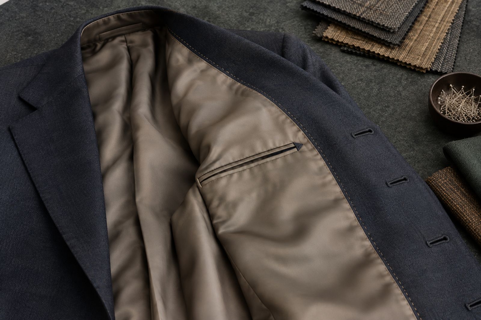 The inside of a finished jacket showing a hand-felled lining, an inside pocket and hand-worked buttonholes.